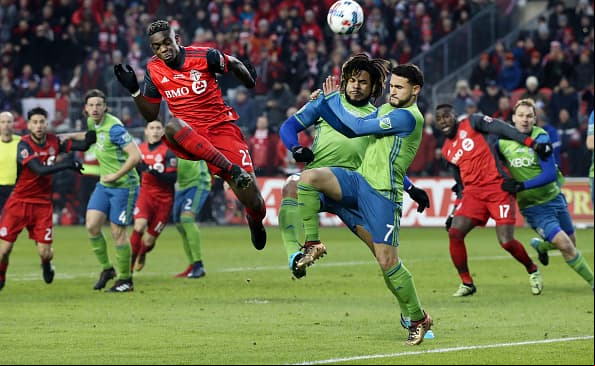 TORONTO, ON - DECEMBER, 9 In first half action, Toronto FC defender Chris Mavinga (23) puts the ball towards the net around a lot of traffic. The TFC (Toronto Football Club) took on the Seattle Sounders in the MLS Cup Final at BMO field in Toronto. It is the second year in a row the two faced off in the final. Soccer, pitch, ball, championship, players, team sport December, 9 2017 (Richard Lautens/Toronto Star via Getty Images)