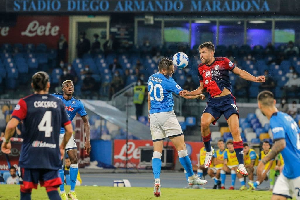 Napoli's Polish midfielder Piotr Zielinski (C) and Cagliari's Dutch midfielder Kevin Strootman go for a header during the Italian Serie A between Napoli and Cagliari on September 26, 2021 at the Diego-Maradona stadium in Naples. (Photo by Carlo Hermann / AFP) (Photo by CARLO HERMANN/AFP via Getty Images)