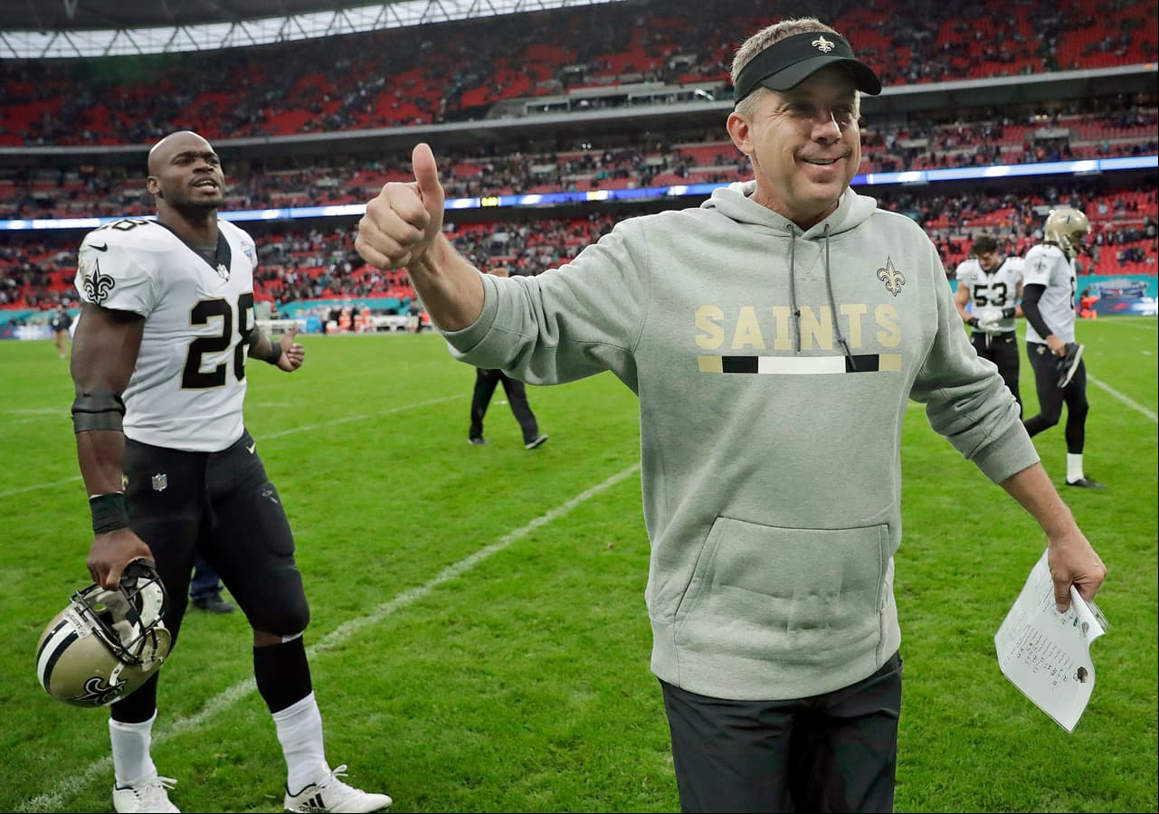 FILE - In this Sunday Oct. 1, 2017, file photo, New Orleans Saints head coach Sean Payton and running back Adrian Peterson gesture as they leaves the field after an NFL football game against the Miami Dolphins at Wembley Stadium in London. In the Saints’ first four games this year, they went from double-digit losses the first two weeks, to wins by 20 or more the next two. (AP Photo/Matt Dunham, File)