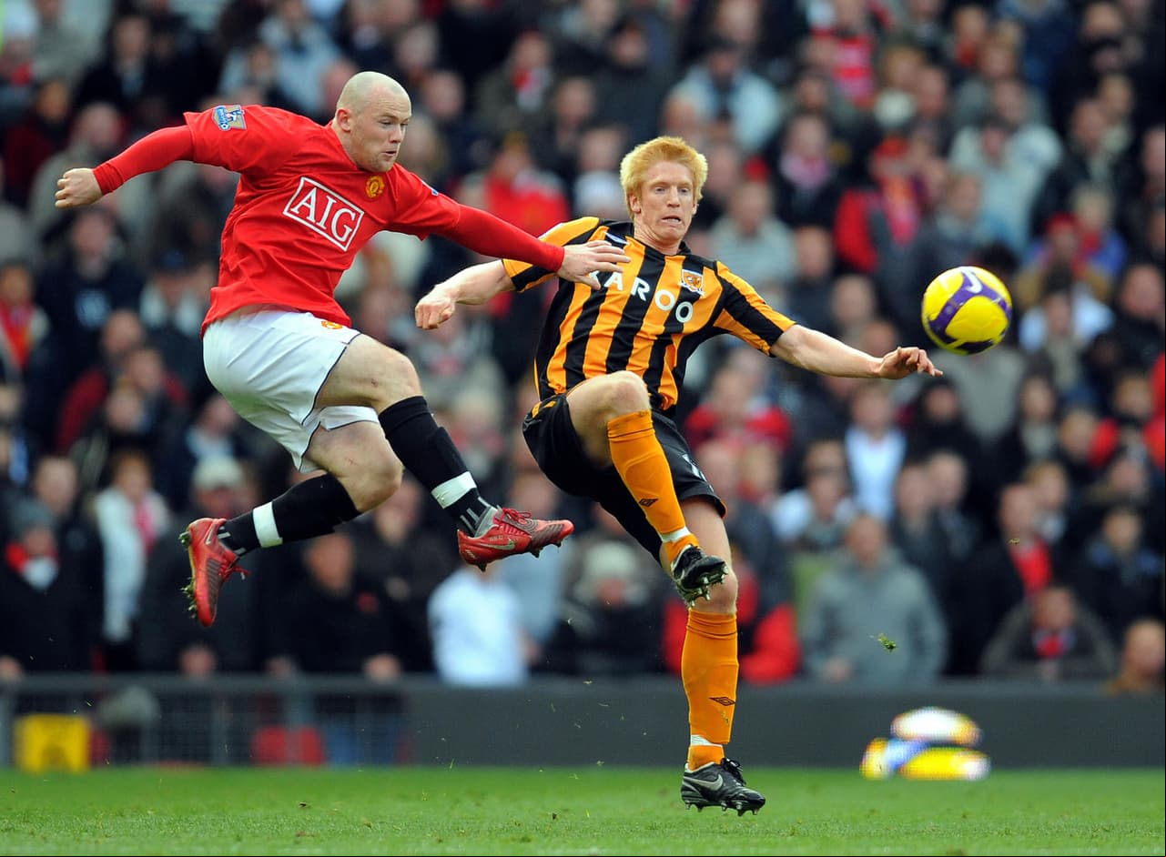 Manchester United's English forward Wayne Rooney (L) vies with Hull City's Irish defender Paul McShane during the English Premier league football match at Old Trafford, in Manchester on November 1 2008. AFP PHOTO/ANDREW YATES Mobile and website use of domestic English football pictures are subject to obtaining a Photographic End  Licence from Football DataCo Ltd Tel : +44 (0) 207 864 9121 or e-mail accreditations@football-dataco.com - applies to Premier and Football League matches. (Photo credit should read ANDREW YATES/AFP/Getty Images)