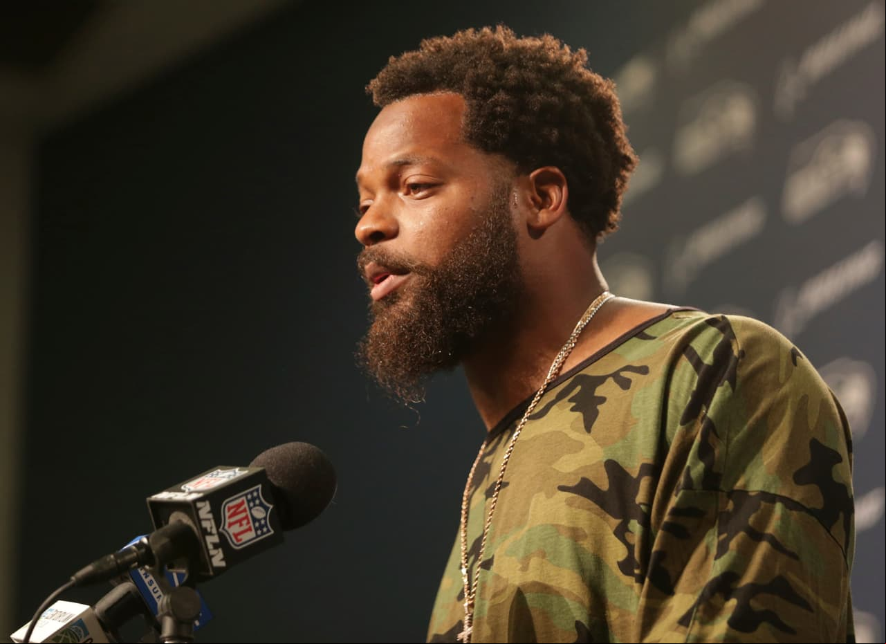 Seattle Seahawks defensive end Michael Bennett talks to reporters following an NFL preseason football game against the Minnesota Vikings, Friday, Aug. 18, 2017, in Seattle. (AP Photo/Scott Eklund)