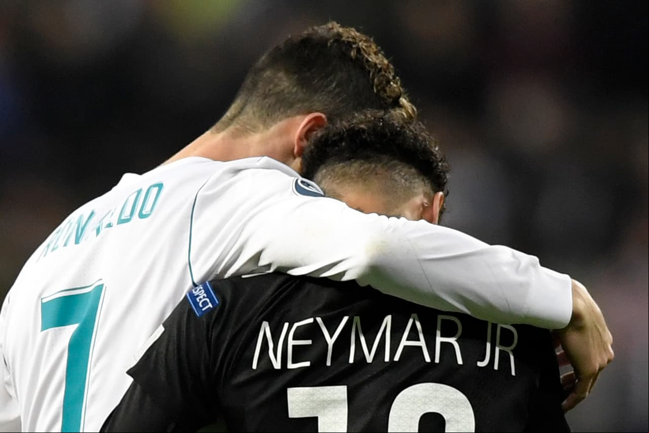 TOPSHOT - Real Madrid's Portuguese forward Cristiano Ronaldo (L) and Paris Saint-Germain's Brazilian forward Neymar leave the pitch during the UEFA Champions League round of sixteen first leg football match Real Madrid CF against Paris Saint-Germain (PSG) at the Santiago Bernabeu stadium in Madrid on February 14, 2018. / AFP PHOTO / GABRIEL BOUYS (Photo credit should read GABRIEL BOUYS/AFP/Getty Images)