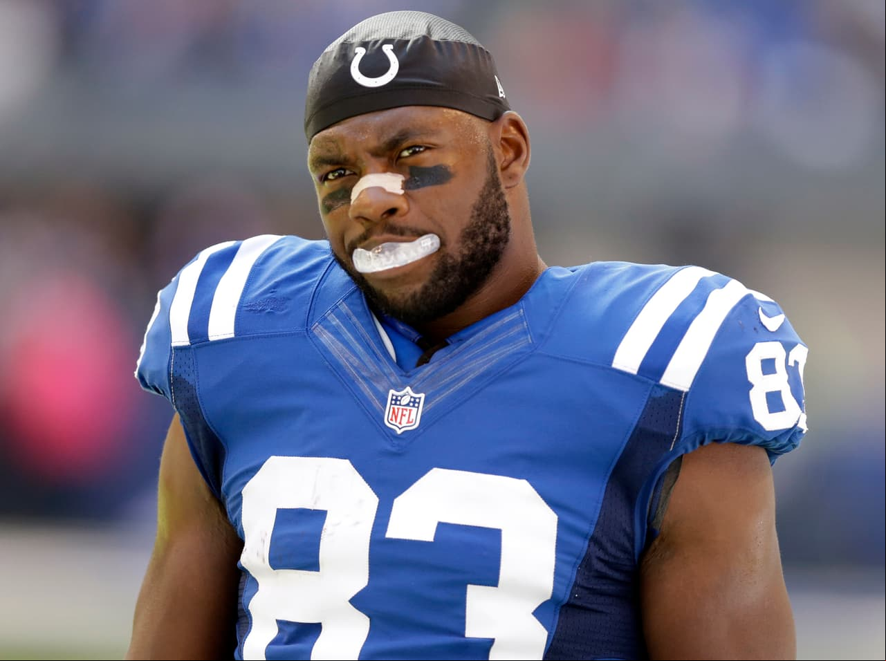 FILE - In this Sunday, Oct. 9, 2016, file photo, Indianapolis Colts tight end Dwayne Allen looks on before an NFL football game against the Chicago Bears in Indianapolis. Allen has dropped to his knee at the end of the national anthem since his rookie season in 2012. So when he offered his customary pregame prayer Sunday night, he never imagined the furor it would cause. The action that was misinterpreted as part of a protest movement started by 49ers quarterback Colin Kaepernick. Allen and the Indianapolis Colts released a video Tuesday explaining what had happened. (AP Photo/Michael Conroy, File)