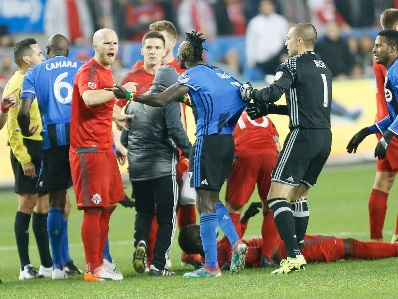 Nov 30, 2016; Toronto, Ontario, CAN; Toronto FC midfielder Michael Bradley (4) and Montreal Impact forward Dominic Oduro (7) exchange wordsas he is held back by Montreal Impact goalkeeper Evan Bush (1) in the second leg of the MLS Eastern Conference Championship at BMO Field. Mandatory Credit: John E. Sokolowski-USA TODAY Sports