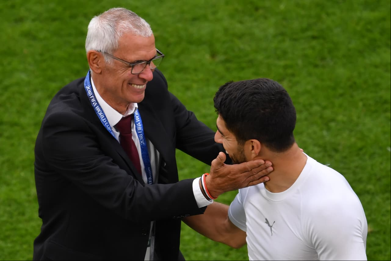 Uruguay's forward Luis Suarez (R) greets Egypt's coach Hector Raul Cuper (L) after the final whistle of the Russia 2018 World Cup Group A football match between Egypt and Uruguay at the Ekaterinburg Arena in Ekaterinburg on June 15, 2018. (Photo by HECTOR RETAMAL / AFP) / RESTRICTED TO EDITORIAL USE - NO MOBILE PUSH ALERTS/S (Photo credit should read HECTOR RETAMAL/AFP/Getty Images)